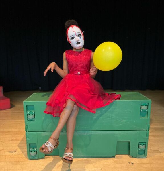 Young performer balancing a ball during a stage exercise in an acting workshop for kids in Miami 